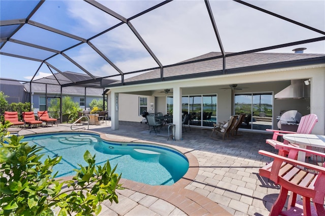 view of swimming pool featuring ceiling fan, a lanai, and a patio area