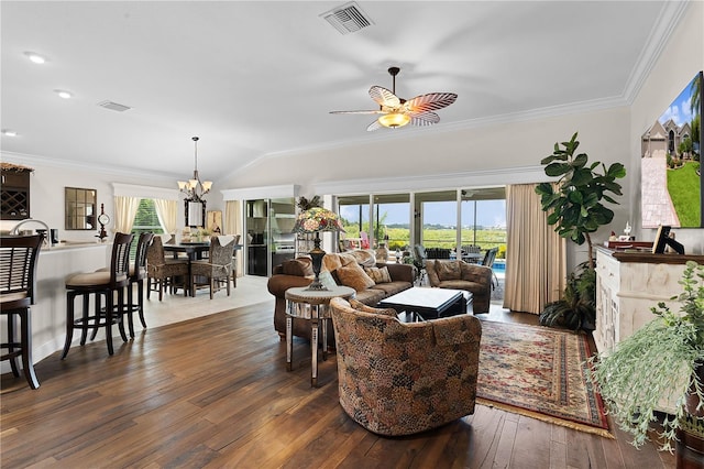 living room with ceiling fan with notable chandelier, vaulted ceiling, dark hardwood / wood-style floors, and ornamental molding