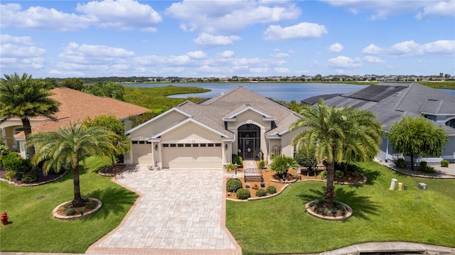 ranch-style home with a water view, a garage, and a front yard