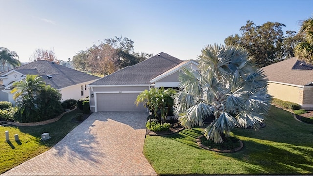 view of front facade featuring a front yard and a garage