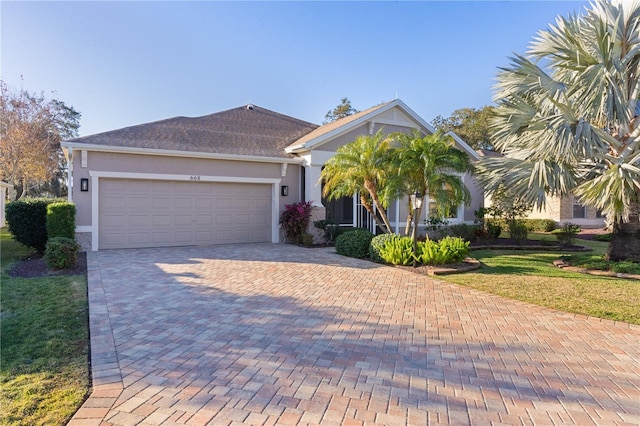 view of front of home featuring a front yard and a garage