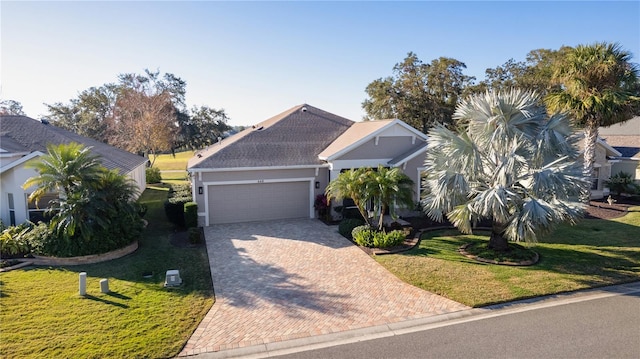 view of front of house featuring a garage and a front lawn