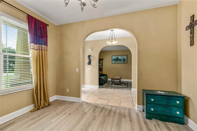 interior space with a textured ceiling and light wood-type flooring