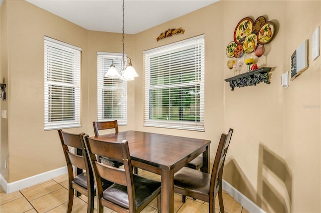 tiled dining room with heating unit, a wealth of natural light, and an inviting chandelier