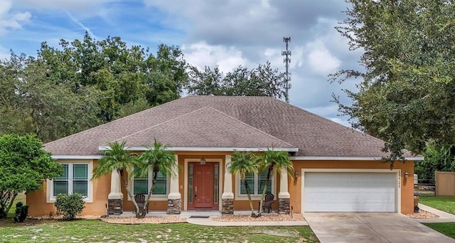 view of front facade featuring a front yard and a garage