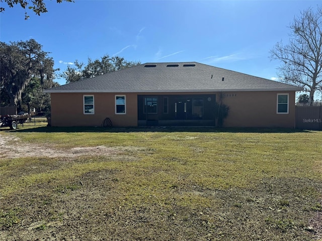 back of property featuring a lawn