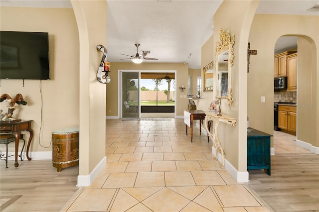 tiled foyer featuring ceiling fan