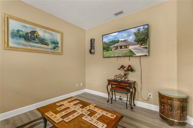 interior space with hardwood / wood-style flooring and a textured ceiling