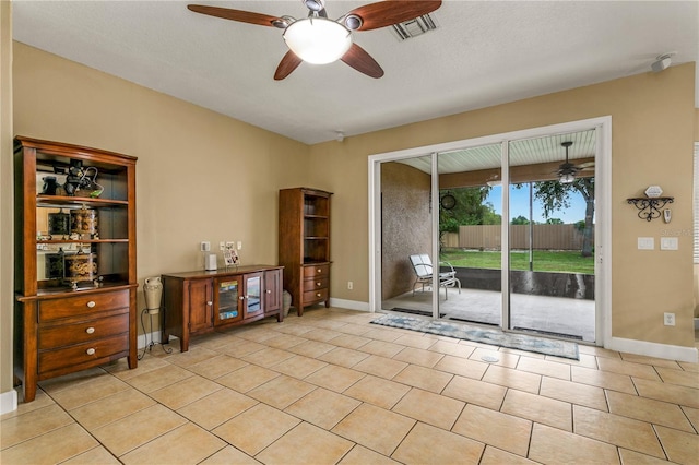 interior space featuring light tile patterned flooring, ceiling fan, and a textured ceiling