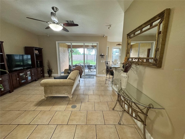 tiled living room with ceiling fan