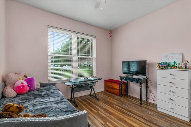 bedroom with dark hardwood / wood-style flooring and ceiling fan