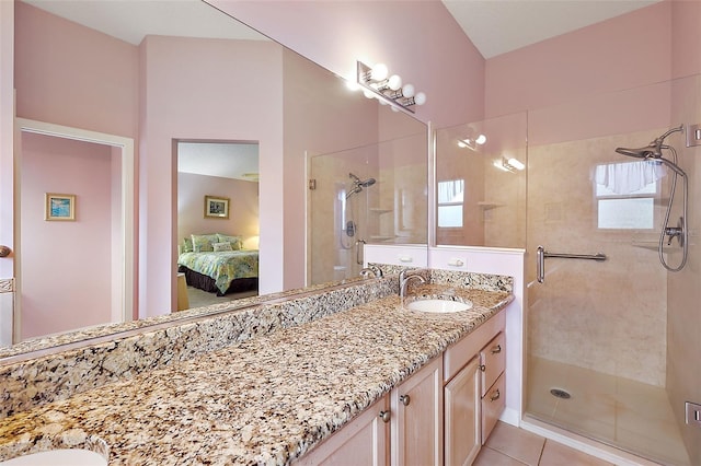 full bath featuring ensuite bathroom, a stall shower, tile patterned flooring, and vanity