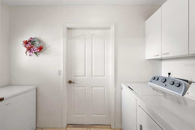 laundry area with washing machine and clothes dryer and cabinet space