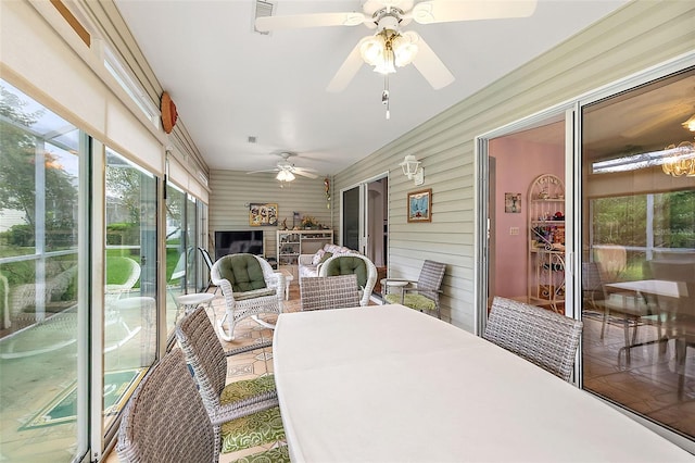 sunroom featuring a ceiling fan and visible vents