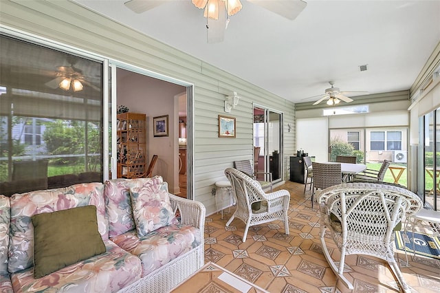 sunroom / solarium featuring visible vents and ceiling fan