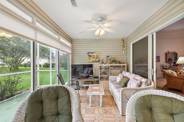 sunroom with ceiling fan and visible vents