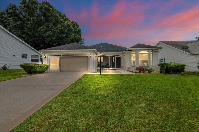 view of front of home featuring a garage and a lawn