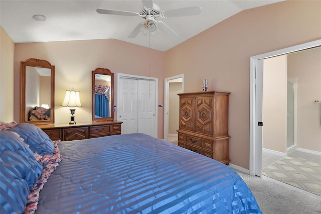 bedroom with ceiling fan, light colored carpet, a closet, and lofted ceiling