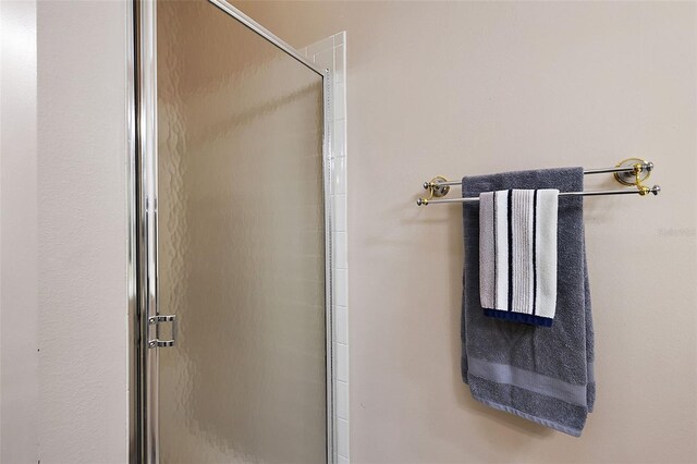 bathroom with a shower with shower door