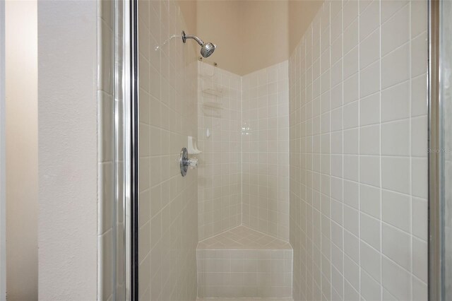 bathroom with a tile shower