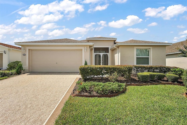 view of front of house featuring a garage and a front yard