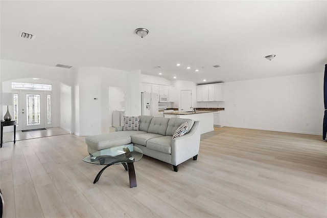 living room featuring sink and light wood-type flooring