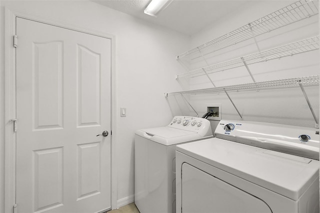 clothes washing area featuring washer and dryer