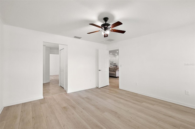 unfurnished room with ceiling fan and light wood-type flooring