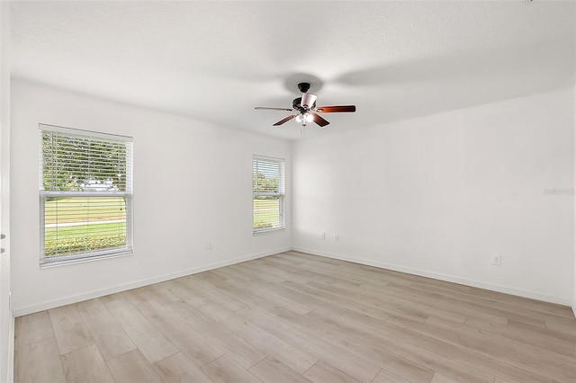 spare room featuring light hardwood / wood-style flooring and ceiling fan