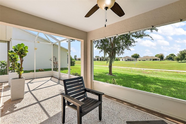 sunroom featuring ceiling fan