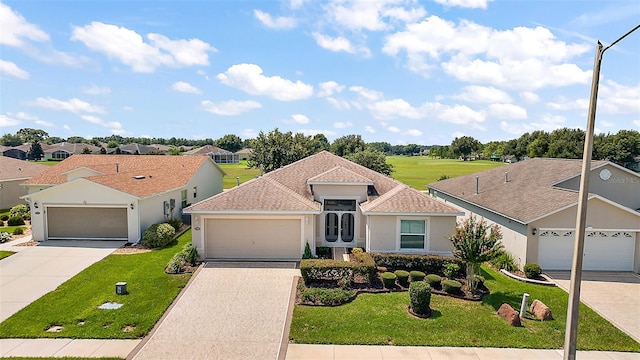 view of front of home featuring a garage and a front yard