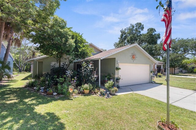 view of front of home with a front lawn and a garage