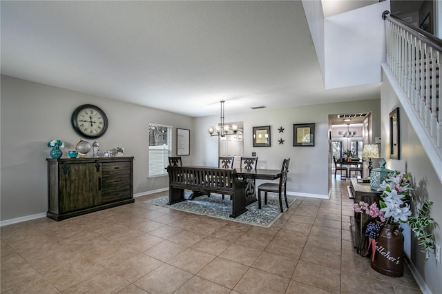 dining area featuring a notable chandelier, visible vents, light tile patterned flooring, baseboards, and stairs