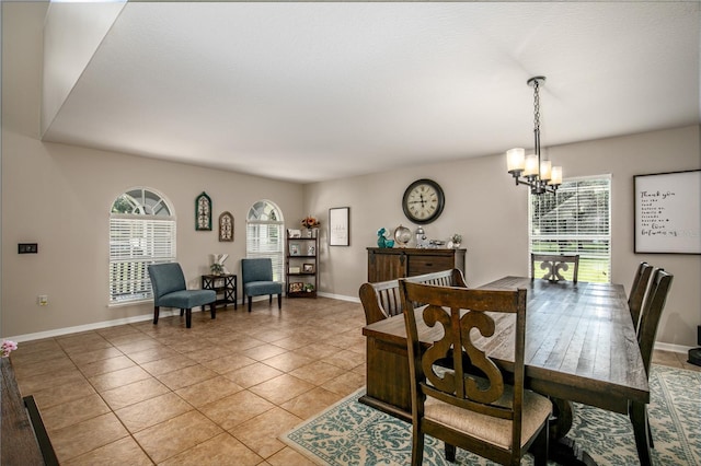 dining space with light tile patterned floors, baseboards, and a notable chandelier