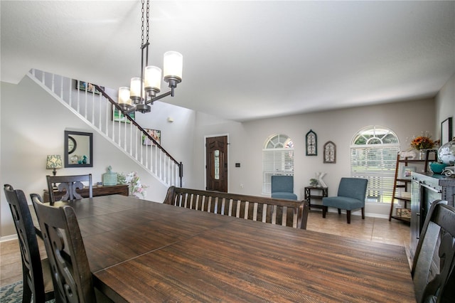 dining room featuring stairs, tile patterned floors, a chandelier, and baseboards