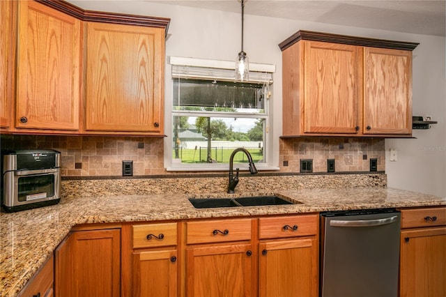 kitchen with light stone countertops, dishwasher, tasteful backsplash, and a sink