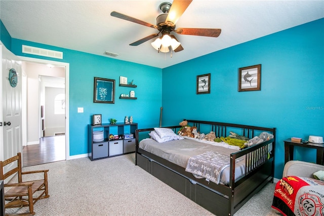 bedroom with baseboards, visible vents, and a ceiling fan