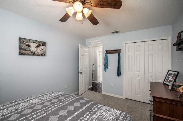 bedroom with carpet floors, a closet, visible vents, a textured ceiling, and baseboards