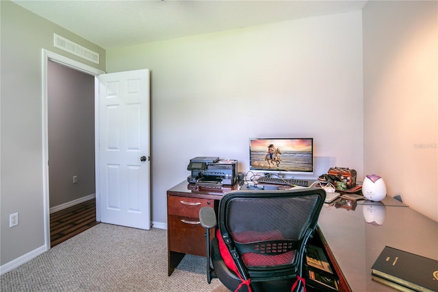 carpeted office space with baseboards and visible vents