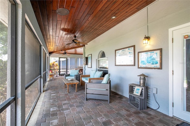 sunroom / solarium featuring vaulted ceiling and wood ceiling