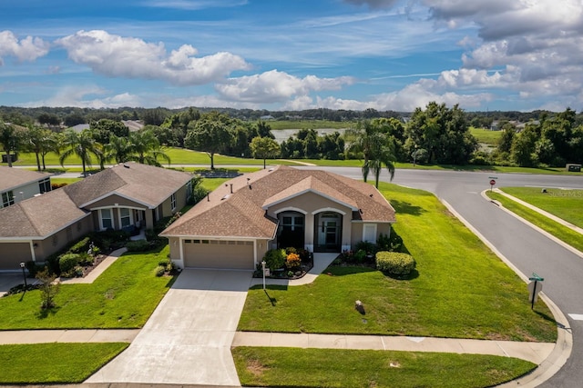 view of front of house featuring a garage and a front yard