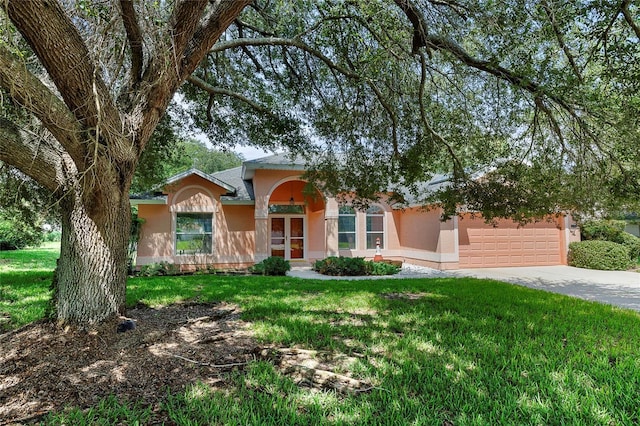 view of front of home with a garage and a front lawn