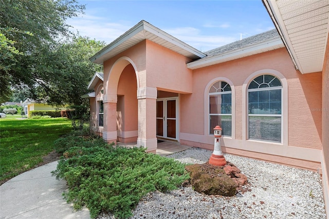 doorway to property featuring a yard