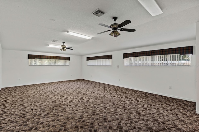 unfurnished room featuring ceiling fan, a textured ceiling, and carpet flooring