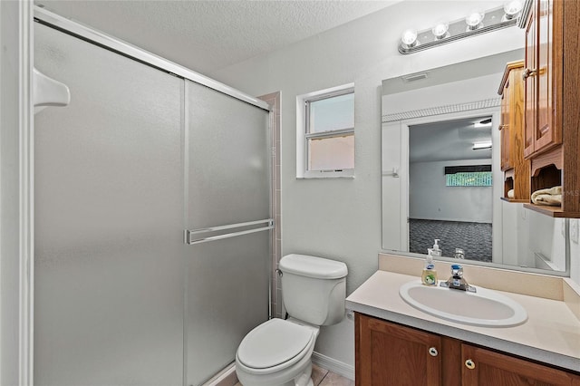 bathroom featuring an enclosed shower, tile patterned floors, a textured ceiling, vanity, and toilet