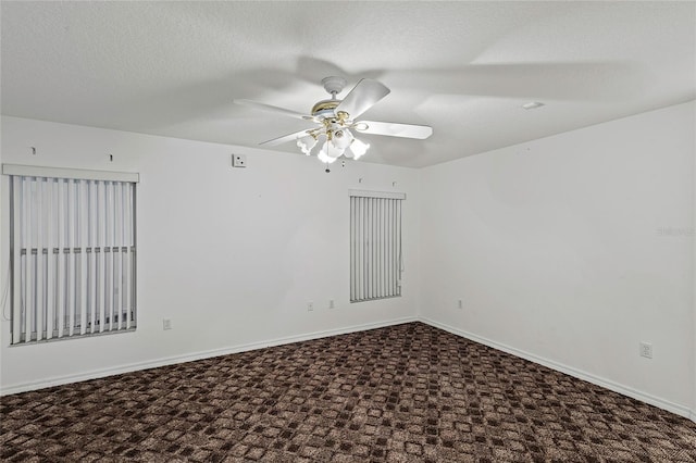 spare room featuring ceiling fan, carpet, and a textured ceiling