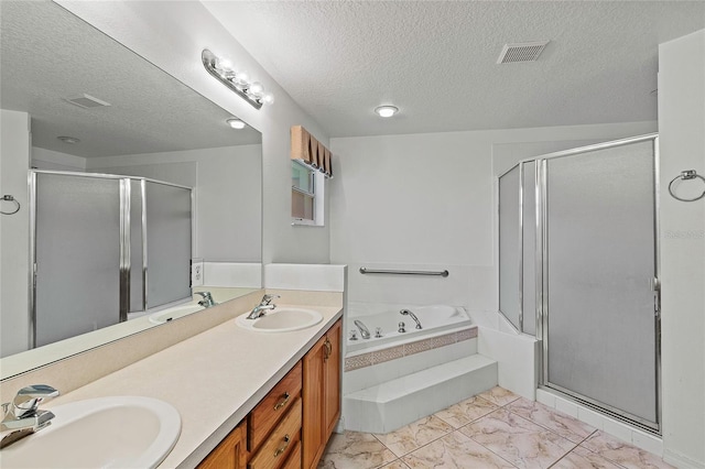 bathroom with a textured ceiling, separate shower and tub, dual vanity, and tile patterned floors