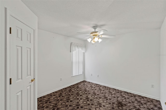 empty room featuring ceiling fan and a textured ceiling