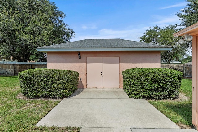 exterior space with an outbuilding and a lawn