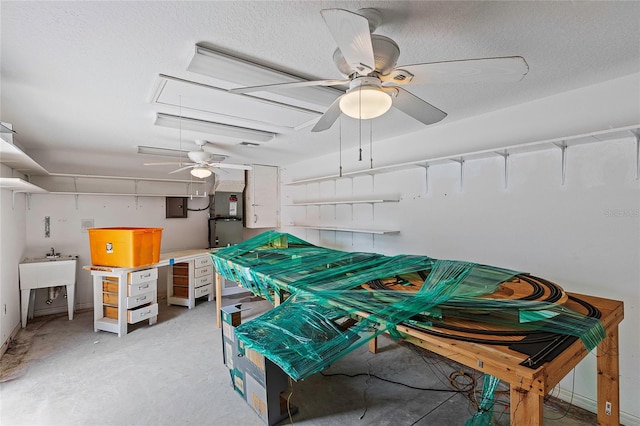 garage featuring ceiling fan, sink, and electric panel